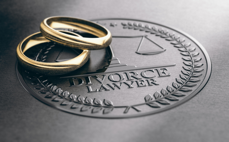 Wedding rings on a divorce lawyer company stamp