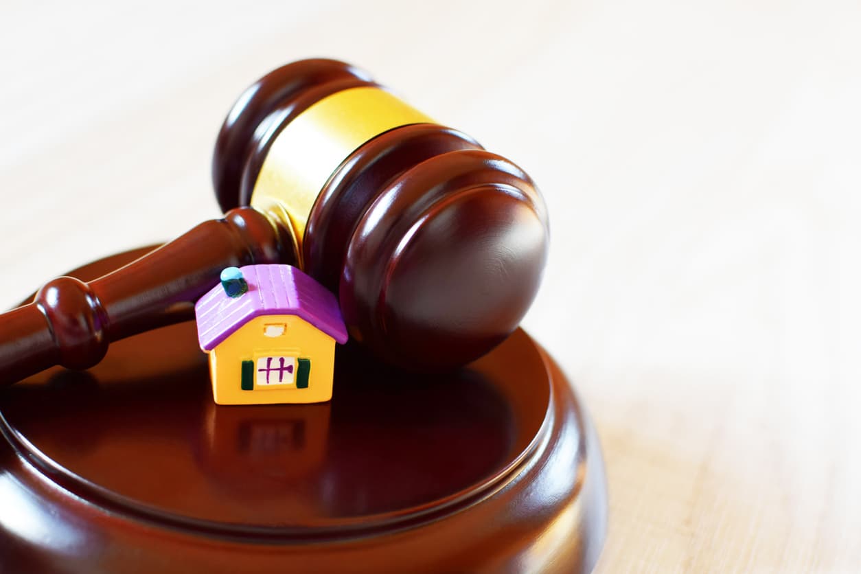 judges gavel with a toy house