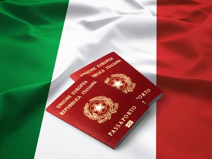 Italian passport on top of an Italian Flag