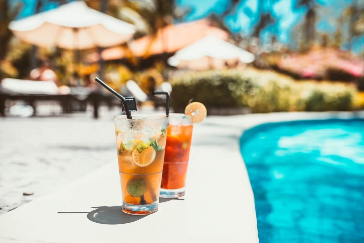 Cpocktails at the side of a swimming pool