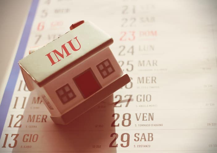 House laying on a calendar with the sign Imu italian tax